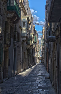 Narrow alley amidst buildings in town