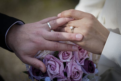 Midsection of bride holding wedding dress