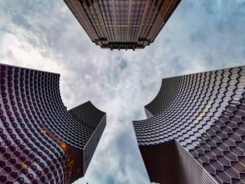 Low angle view of buildings against cloudy sky