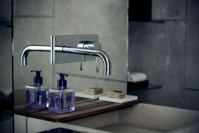 Faucet and soap dispenser in bathroom at home