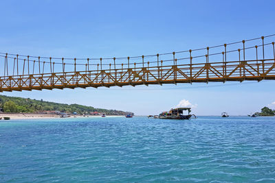 Bridge over sea against sky