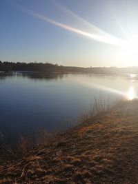 Scenic view of lake against sky during sunset