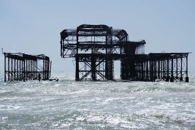 Lifeguard hut in sea against clear sky