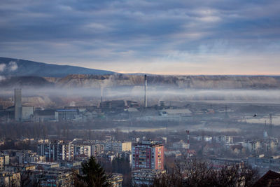 High angle view of buildings in city against sky