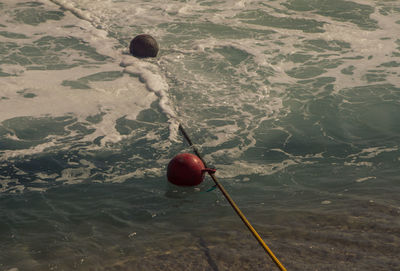 High angle view of red ball in water in the surf of the sea 