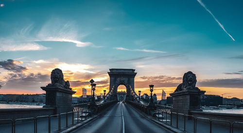 View of bridge against cloudy sky during sunset