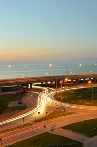 High angle view of light trails on road against sky at night