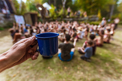 Midsection of people holding drink