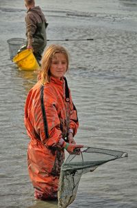 Full length portrait of girl standing in sea