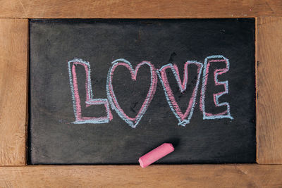 Love, handwriting on blackboard.