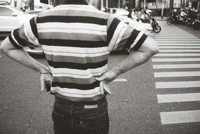 Midsection of man standing on road