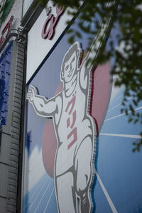 Low angle view of text on building against sky