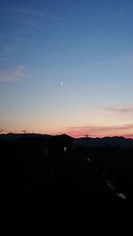 Silhouette landscape against clear sky during sunset