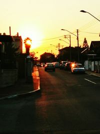 Cars on road at sunset