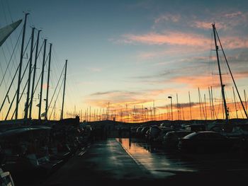 Boats at harbor during sunset