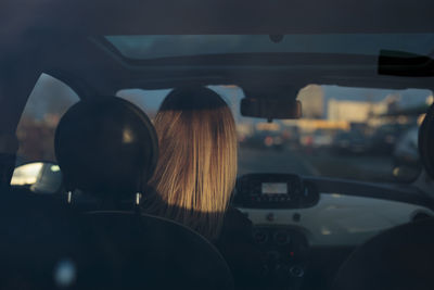 Rear view of man sitting in car