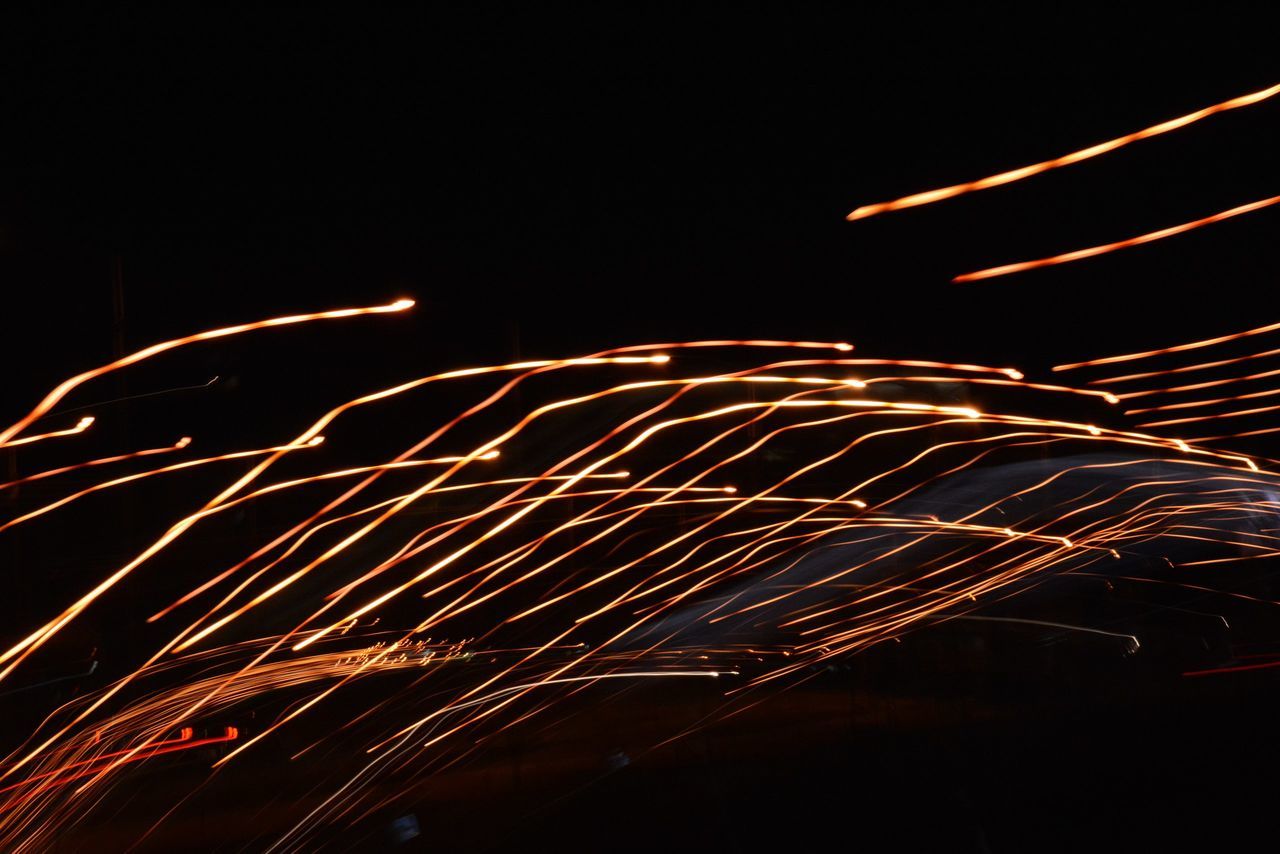 night, long exposure, motion, illuminated, glowing, no people, firework - man made object, blurred motion, speed, firework display, celebration, arts culture and entertainment, light trail, outdoors, low angle view, sky, wire wool, firework, clear sky, close-up