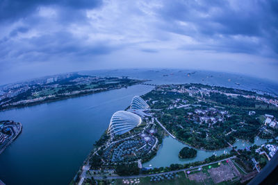 High angle view of cityscape by sea against sky