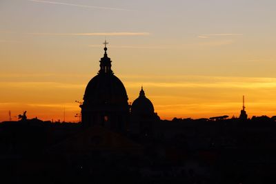 Silhouette of building against sky during sunset