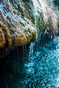 Close-up of water splashing on rock