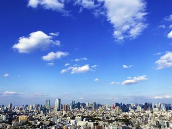 Panoramic view of modern buildings against blue sky