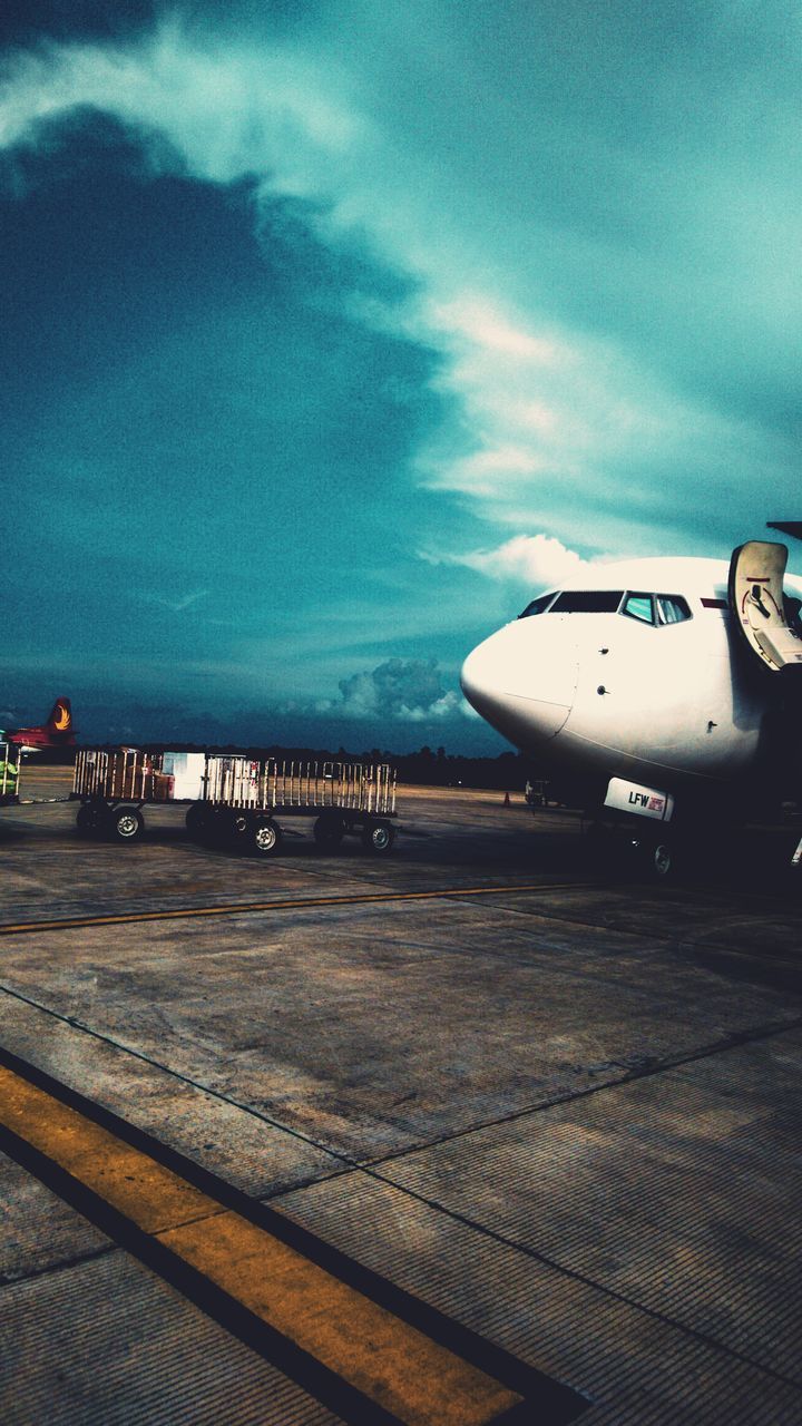 AIRPLANE AT AIRPORT AGAINST SKY