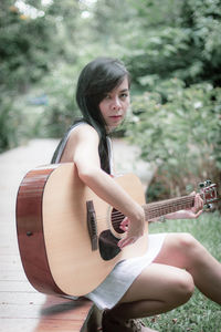 Young woman playing guitar