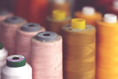 Close-up of colorful spools for sale in store