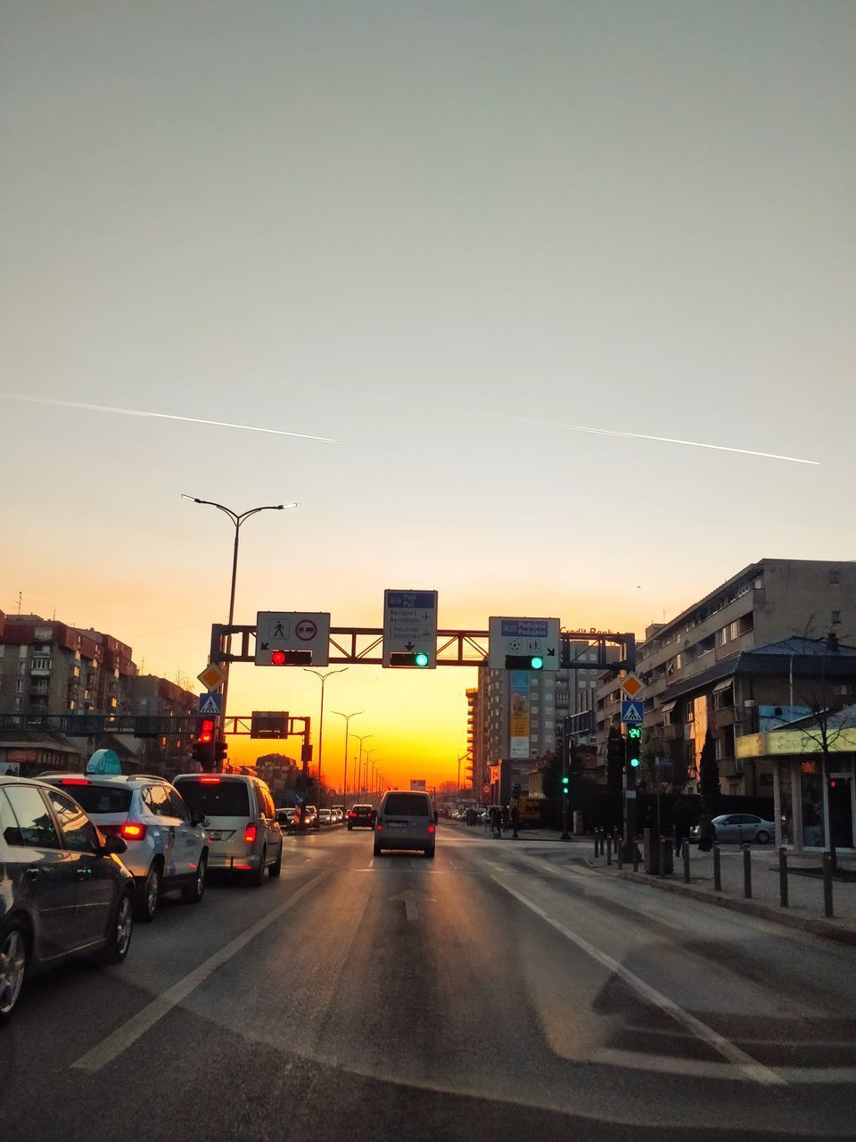 CARS ON ROAD AGAINST BUILDINGS