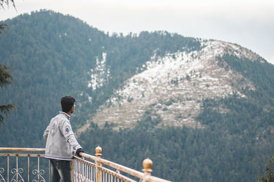 Rear view of man looking at mountains