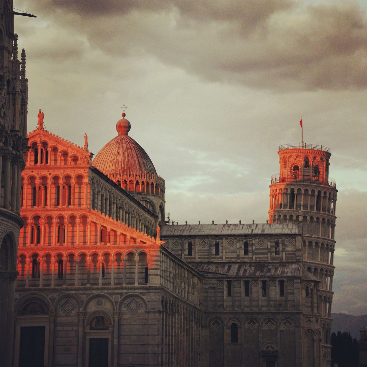 architecture, built structure, building exterior, sky, cloud - sky, red, cloudy, low angle view, cloud, weather, overcast, day, outdoors, no people, city, building, travel destinations, exterior, flag, history