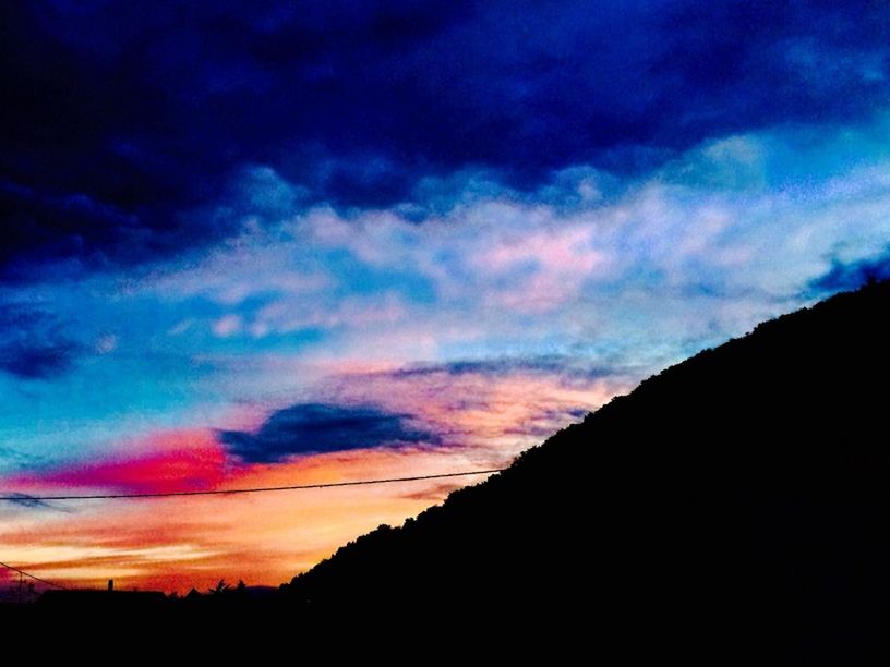 silhouette, sunset, sky, scenics, beauty in nature, tranquil scene, tranquility, cloud - sky, dramatic sky, nature, cloud, dark, landscape, idyllic, orange color, low angle view, dusk, moody sky, blue, cloudy