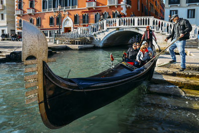 View of boats in canal along buildings