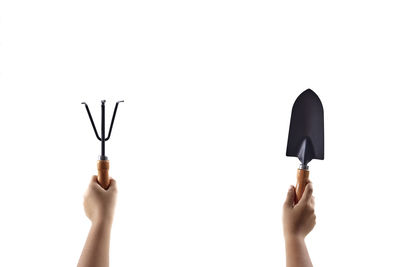 Low section of person holding hands against white background