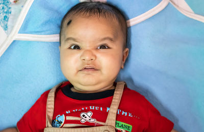 Cute infant facial expressing from top angle indoor shot