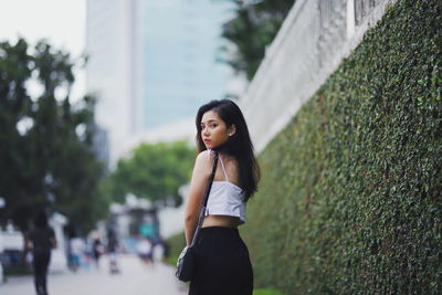 Portrait of woman standing in city