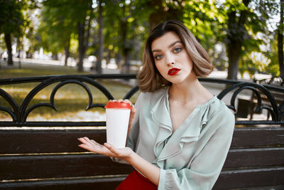 Portrait of beautiful woman holding drink