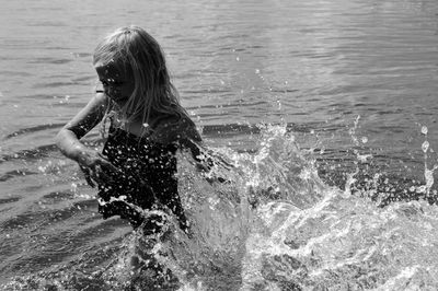 Girl splashing water in sea