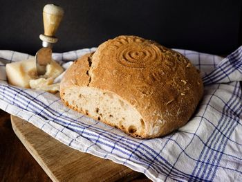 Close-up of bread on table against black background