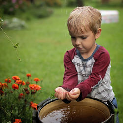 Portrait of cute boy standing on field