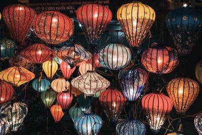 Low angle view of illuminated lanterns hanging at night