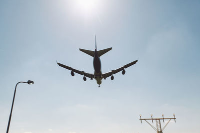 Low angle view of airplane flying against clear sky