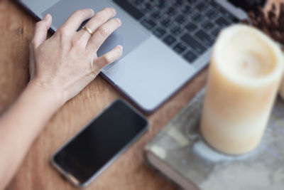 Midsection of man using laptop on table