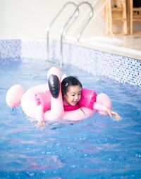 Portrait of cute boy playing in swimming pool