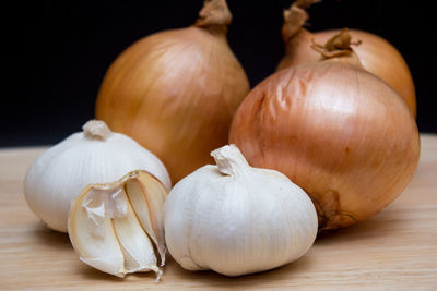 Close-up of pumpkins on table against black background