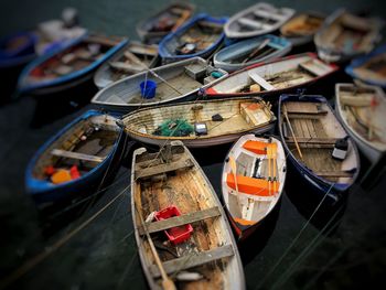 Tilt shift image of boats moored at harbor