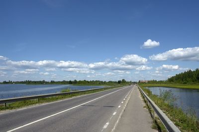 Road by landscape against sky