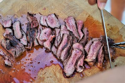 Close-up of person hand on barbecue grill