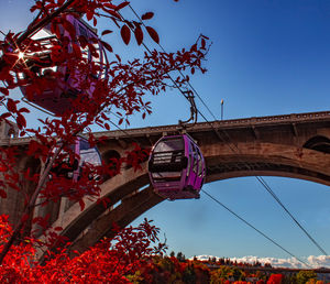 Low angle view of bridge against clear blue sky