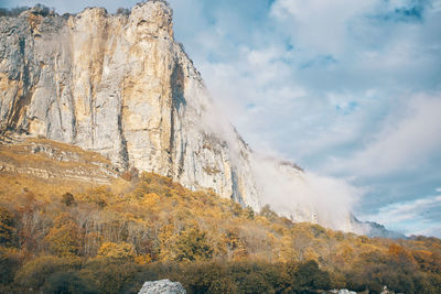 Low angle view of rock formations against sky